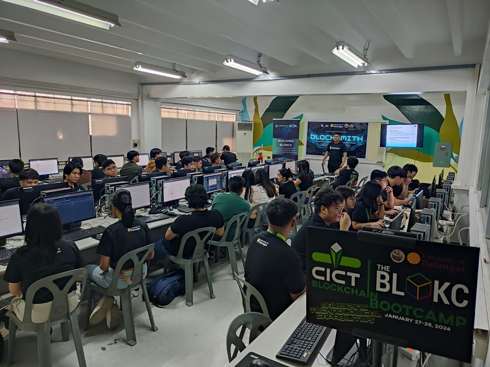Students at workstations in a computer lab during a hands-on The BLOKC blockchain bootcamp.