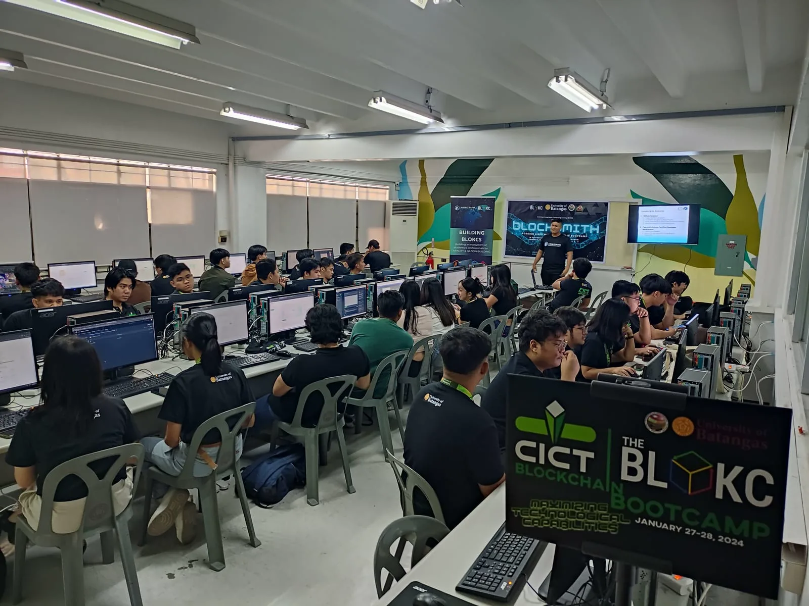 Students at workstations in a computer lab during a hands-on The BLOKC blockchain bootcamp.