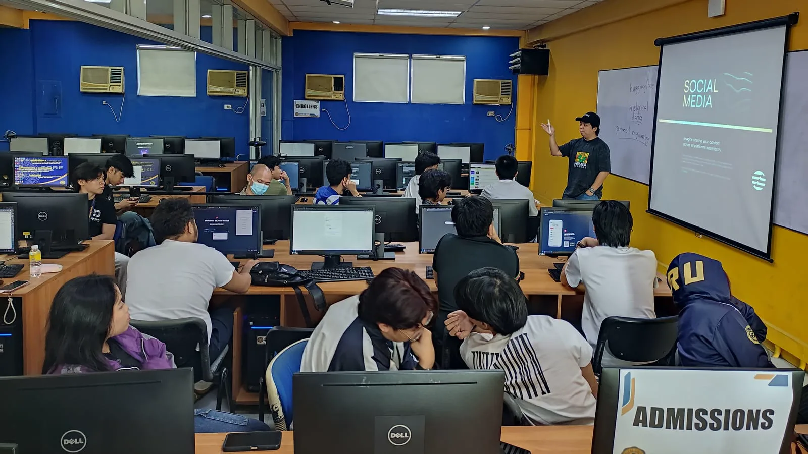 Participants coding on their laptops during a hands-on blockchain bootcamp at The BLOKC