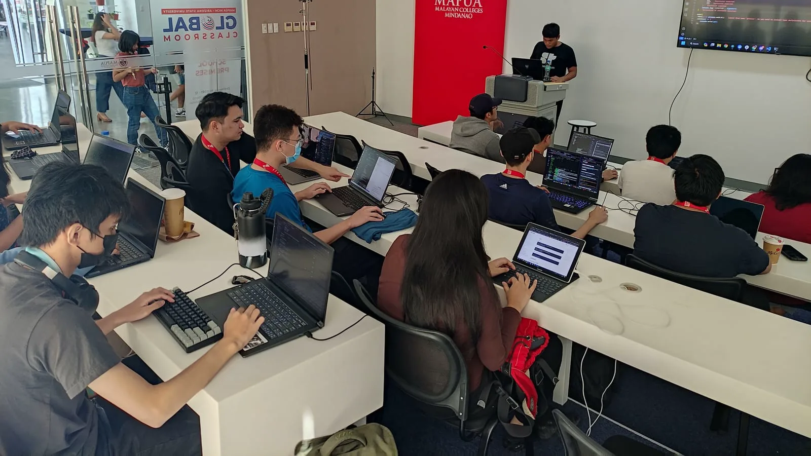 A BLOKC instructor walking developers through smart-contract code on a projector screen