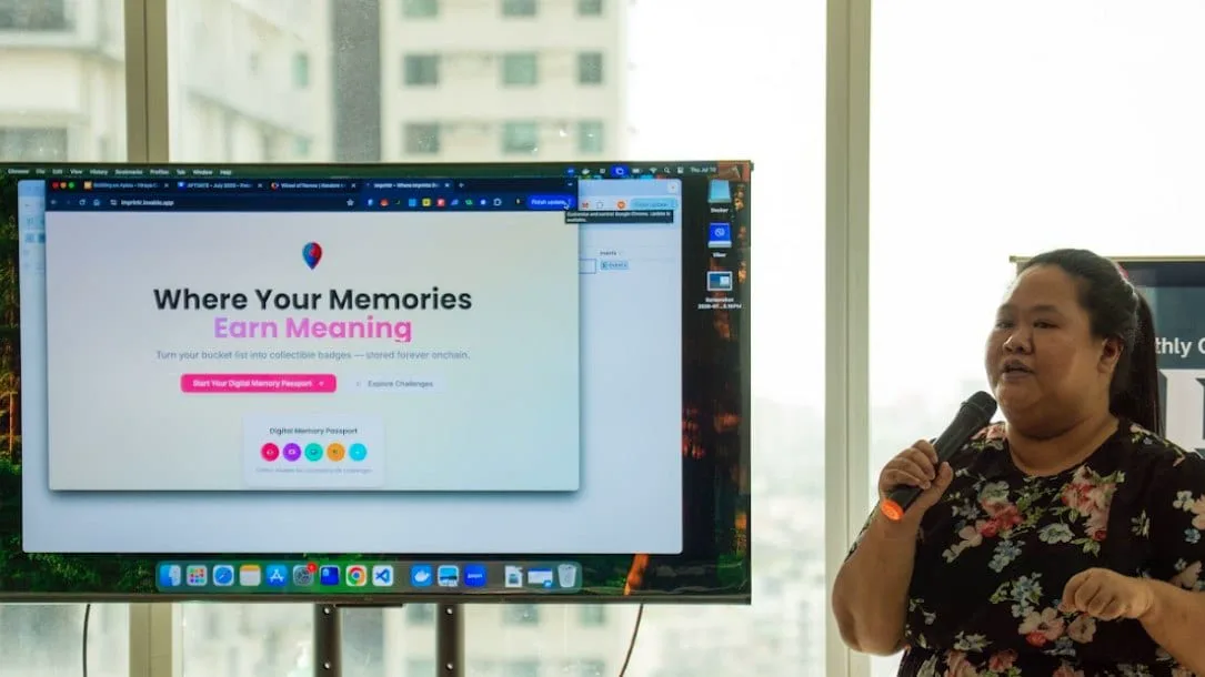 A builder pitches an onchain memory-collectible project beside a screen reading Where Your Memories Earn Meaning.