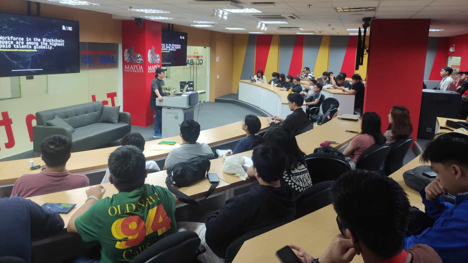 Students fill a Mapúa University Global Classroom lecture hall for a BLOKC blockchain talk led from the podium.